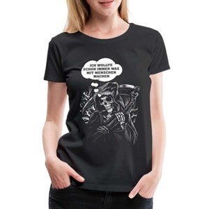 Peut inclure: T-shirt noir avec un graphique du Grim Reaper tenant une faux et une bulle de pensée qui dit "Ich wollte schon immer was mit Menschen machen".
