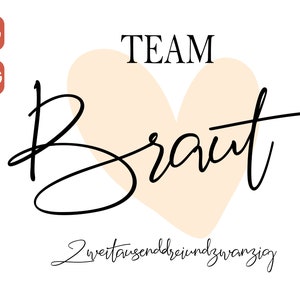 May include: A black and white graphic design with the text "TEAM BRAUT" in a cursive font. A peach-colored heart shape is behind the text. The text "zweitausenddreiundzwanzig" is below the heart.