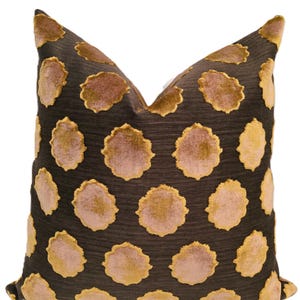 May include: Decorative throw pillow with a dark brown background and a pattern of large, light brown and gold floral shapes. The pillow has a soft, textured appearance and a classic design.
