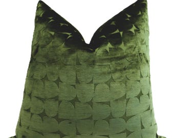 May include: A green velvet pillow with a geometric pattern. The pattern is made up of overlapping circles and stars.