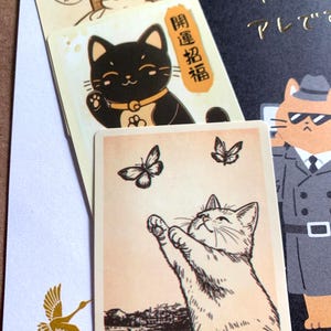 Hand illustrated cat stationery detail showing small art cards and Japanese paper textures from mystery bundle