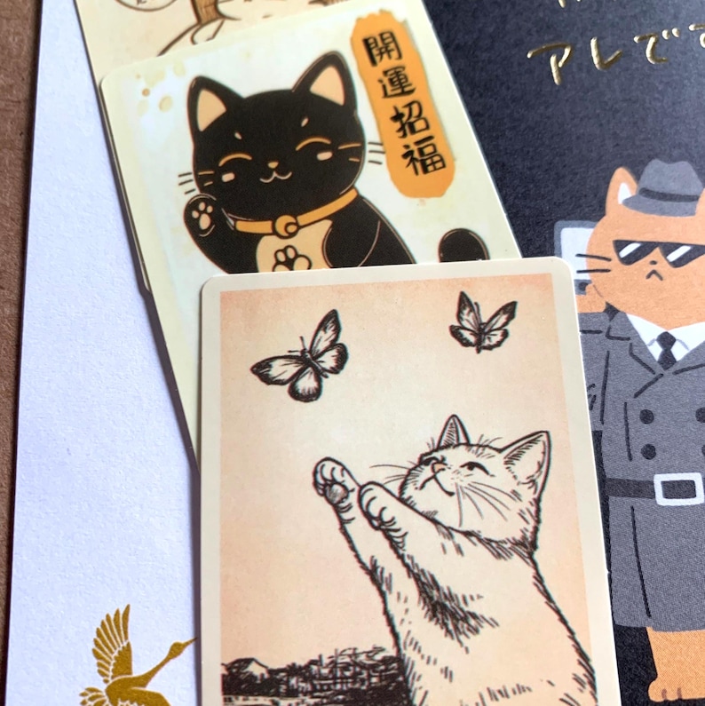 Hand illustrated cat stationery detail showing small art cards and Japanese paper textures from mystery bundle