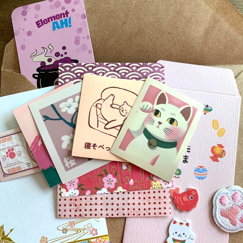 Close up of cat themed Japanese memo sheet and sticker flakes from Lucky Cat Curiosity Drawer mystery bundle