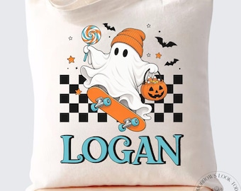 May include: A white canvas tote bag featuring a graphic of a ghost wearing an orange beanie, riding an orange skateboard, holding a lollipop and a jack-o'-lantern bucket. The design includes a black and white checkerboard pattern and the name LOGAN.