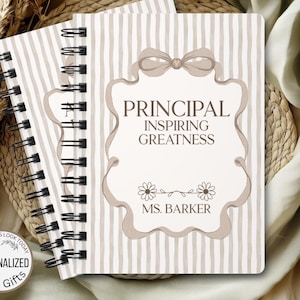 May include: Two spiral-bound notebooks with beige and white striped covers. The front notebook features a decorative frame with the words "PRINCIPAL INSPIRING GREATNESS" and "MS. BARKER". A circular sticker reads "PERSONALIZED BEST GIFTS".
