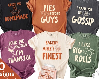 May include: A collection of six short-sleeve t-shirts in black, orange, charcoal, maroon, cream, and green, each featuring unique text and graphics. A hand holds a plaid beverage can cooler labeled Thanksgiving 2024 The Millers Cheers.