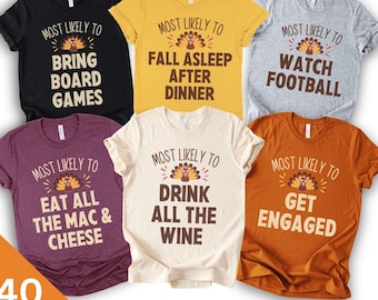 May include: Six short-sleeved t-shirts in black, yellow, gray, maroon, cream, and orange. Each shirt features a turkey graphic and the text Most Likely To followed by phrases like Bring Board Games, Fall Asleep After Dinner, Watch Football, Eat All The Mac & Cheese, Drink All The Wine, and Get Engaged.