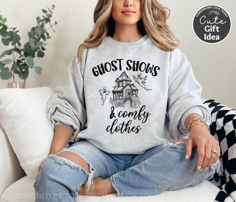 May include: A gray sweatshirt with the text "Ghost Shows & Comfy Clothes" and a black and white illustration of a haunted house with ghosts.