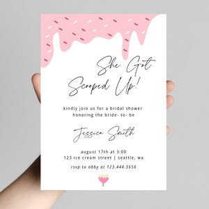 May include: Pink bridal shower invitation with a dripping ice cream cone graphic. The text reads "She Got Scooped Up!" and includes the bride-to-be's name, Jessica Smith, the date and time of the shower, the address, and RSVP information.