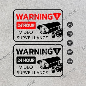 以下が含まれることがあります： 赤色の感嘆符が付いた白黒の警告標識。標識には「WARNING 24 HOUR VIDEO SURVEILLANCE」と書いてあります。標識には、白黒のセキュリティカメラのイラストが描かれています。
