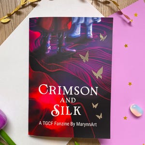 May include: A black and red fanzine titled "Crimson and Silk: A TGCF Fanzine by MarynnArt" with a colourful illustration of two figures and butterflies.