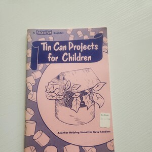 May include: A vintage booklet titled "Tin Can Projects for Children" with a pink and blue cover. The cover features illustrations of tin can crafts and the text "Another Helping Hand for Busy Leaders."