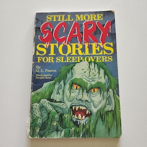 May include: A vintage paperback book titled "Still More Scary Stories for Sleep-Overs." The cover features a green monster with sharp teeth and yellow eyes. The title is in red letters with a dripping effect.