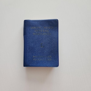 May include: A white ceramic mug with a black handle and the text "But First, Coffee" in a black, bold font. The mug is on a white surface. The mug is 4 inches tall.