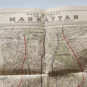May include: A vintage map of Manhattan, New York City, with a scale of 2600 feet to 1 inch. The map shows the area around Van Cortlandt Park and the Bronx, including the Botanical Gardens. The map is printed on aged paper and has a faded, yellowed appearance.