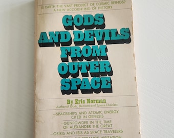 May include: Vintage paperback book titled "Gods and Devils From Outer Space" by Eric Norman. The cover features bold turquoise lettering against a beige background. The book explores the intersection of cosmic beings and history.