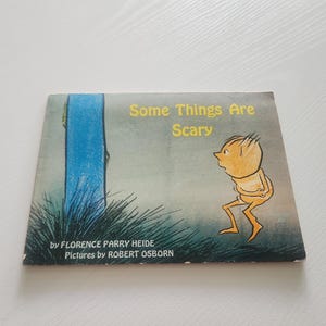 May include: A vintage children's book titled "Some Things Are Scary" by Florence Parry Heide, with illustrations by Robert Osborn. The cover features a scared cartoon figure in front of a blue shape and green grass.