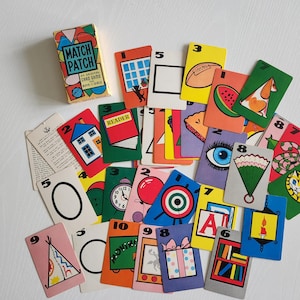 May include: A vintage Match Patch card game box and assorted cards. The box is yellow, blue, and red with the game title. The cards feature colorful illustrations of various objects, numbers, and letters. The game is an original card game for boys and girls.
