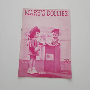May include: A vintage pink booklet titled "MARY'S DOLLIES" with illustrations of dolls. The cover features a doll in a dress and a doll at a ticket booth. The word "PATSY" is printed on the cover, along with "TICKETS" and "VOLUME NO. 10".