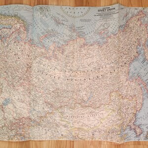 May include: A vintage map of the Soviet Union, featuring detailed geographical information. The map is printed on aged paper with a light blue and beige color scheme. The title "Eastern Soviet Union" is visible at the top.