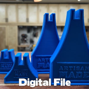 May include: Four blue plastic 3D printed supports of varying sizes. Each support has a U-shaped opening at the top and the words "Artisan Made" printed on the front.