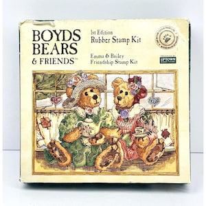 May include: A boxed Boyds Bears & Friends 1st Edition Rubber Stamp Kit. The box features an illustration of two teddy bears, Emma and Bailey, enjoying tea. The bears are dressed in floral attire, with the text "Emma & Bailey Friendship Stamp Kit".