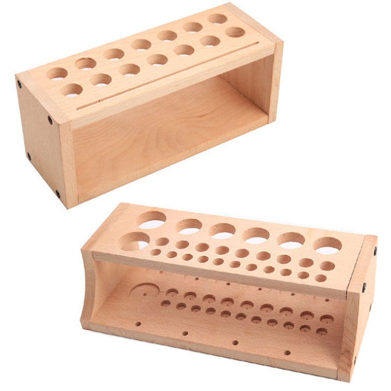 May include: Two wooden storage organizers with multiple round holes for holding paint brushes or other small tools. The organizer on the left has a single shelf, while the organizer on the right has two shelves.