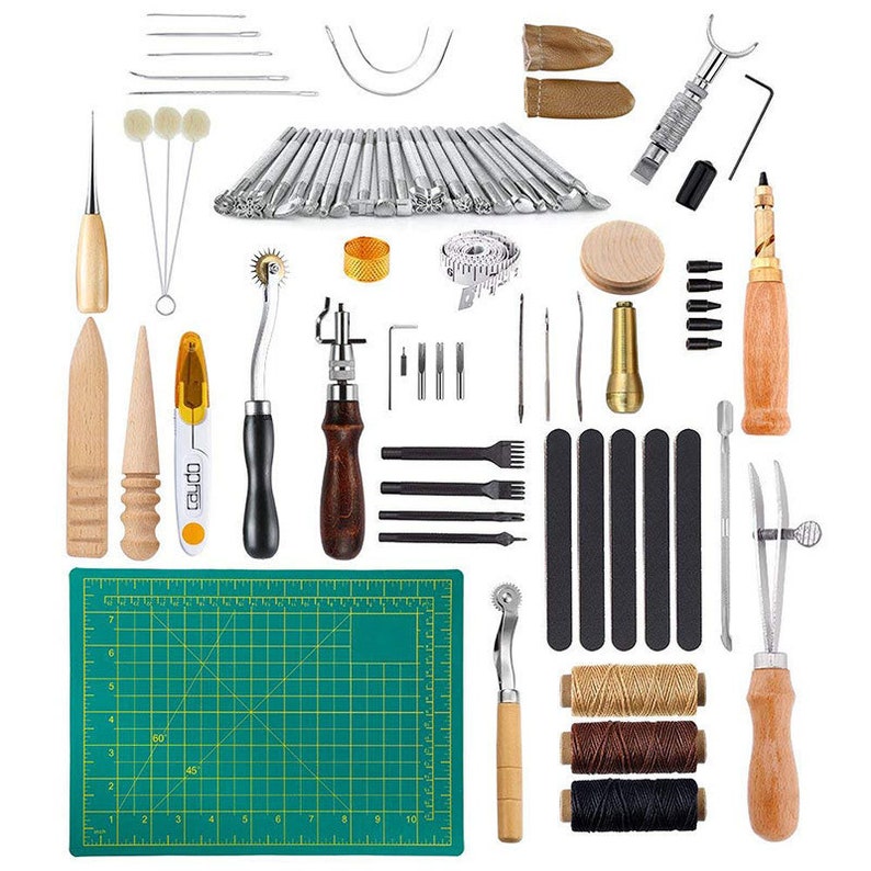 May include: A leather craft tool kit with a variety of tools, including punches, awls, stitching tools, a cutting mat, and thread. The tools are arranged on a white background.