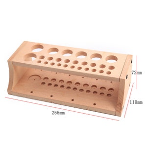 May include: Wooden organizer with multiple holes of different sizes for storing small items. The organizer measures 255 mm in length, 72 mm in height, and 110 mm in width.
