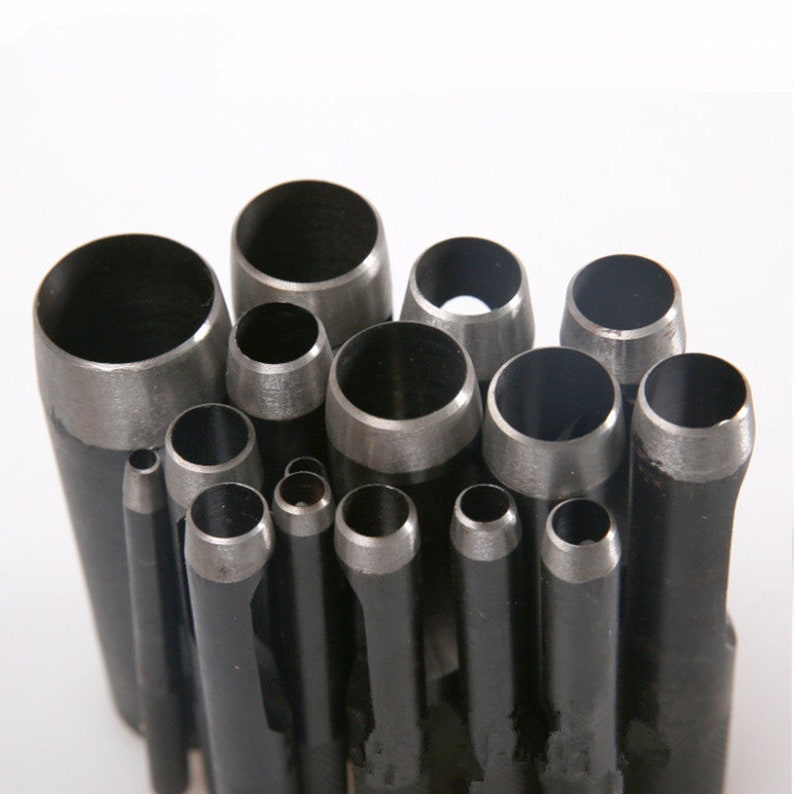 May include: A set of 14 round metal hole punch tools of varying sizes. The tools are arranged in a circular pattern with the largest tool at the top and the smallest tool at the bottom.