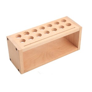 May include: A wooden organizer with a shelf and 18 round holes for storing items like paint tubes or brushes.
