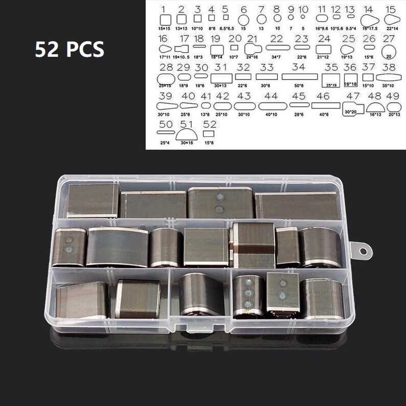 May include: A clear plastic organizer box containing 52 metal craft punches in various shapes and sizes. The sizes are labeled in inches. The text "52 PCS" is in the upper left corner. The punches are for leather, paper, or other craft materials.