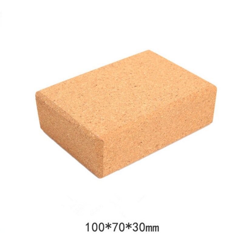 May include: A rectangular yoga block made of light brown cork. The block measures 100mm x 70mm x 30mm. The block is designed to provide support and stability during yoga poses. The block is a solid, rectangular shape with a textured surface.