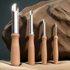 May include: Set of four stainless steel and wood kitchen tools. Each tool has a wooden handle and a stainless steel blade. The tools vary in size and blade shape, designed for different kitchen tasks. The tools are displayed against a neutral background.