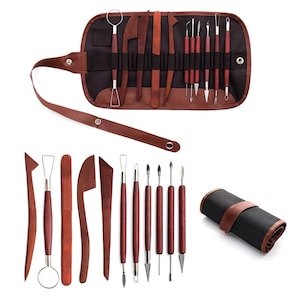 May include: A set of sculpting tools featuring dark wood handles and metal tips, including various shapes for carving and shaping. The collection includes a black and brown fabric roll-up case with individual slots to organise and store the tools.
