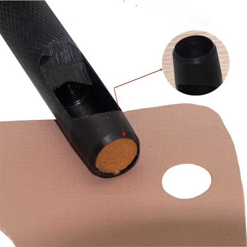 May include: A black leather punch tool with a brown cushioned base, used to create holes in leather. The tool is shown punching a hole in a piece of light brown leather.