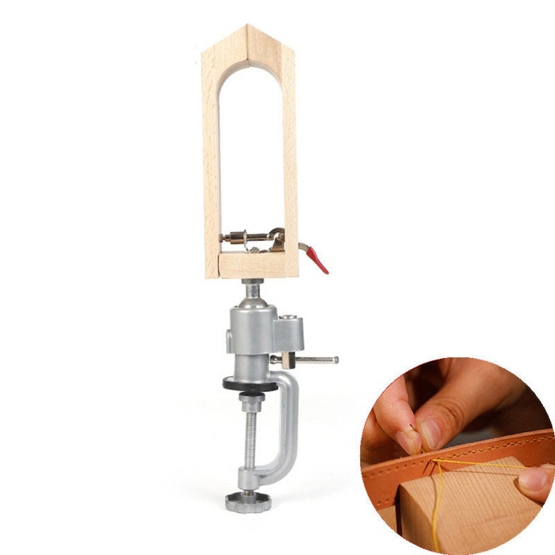 May include: A wooden leather stitching clamp with a metal base and a clamp. The clamp has a lever to tighten the stitching area. The clamp is attached to a metal base with a screw. The base has a clamp to secure it to a table or workbench. A hand is shown stitching leather with a needle and thread.