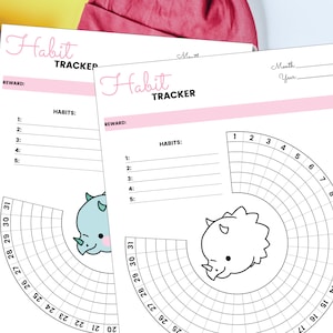 Peut inclure: Deux pages imprimables de suivi des habitudes avec un sch&eacute;ma de couleurs rose et blanc. Chaque page pr&eacute;sente un graphique de dinosaure et un graphique circulaire avec les num&eacute;ros 1 &agrave; 31. Le texte "Habit Tracker" est en haut de chaque page.
