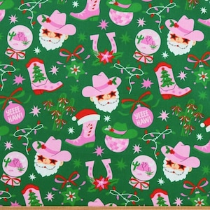 May include: Green fabric featuring a repeating pattern of pink cowboy boots, cowboy hats, Santa faces, snow globes, cacti, and horseshoe designs. The text "YEEEE HAW!" is included. Christmas-themed fabric.