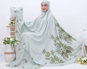 May include: A light green prayer shawl with a floral pattern. The shawl has a ruffled edge and is made of a soft, comfortable fabric.
