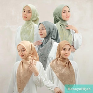 May include: Four women wearing different colored scarves with floral patterns. The scarves are in shades of green, brown, and gray. The women are wearing white shirts and the scarves are tied in a loose knot around their necks. The text "KanayaHijab" is visible in the bottom right corner of the image.
