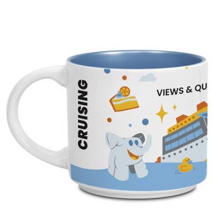 May include: White ceramic mug with a blue interior, featuring a cruise ship design with cartoon characters and the words "CRUISING", "VIEWS & QU", and "QUEUES". The mug has a white handle and a blue base.