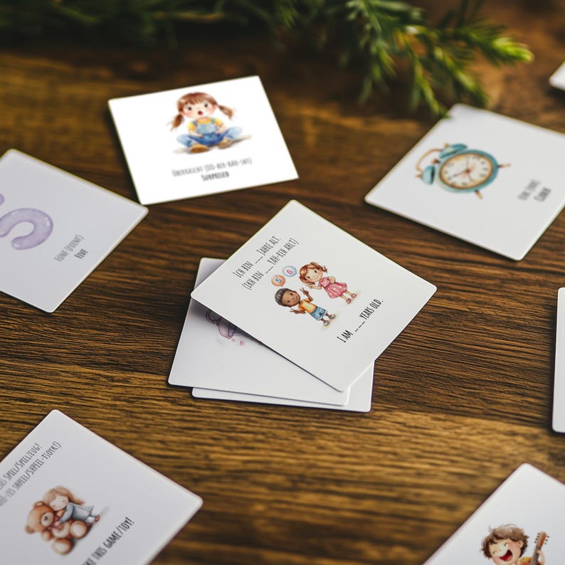 May include: A set of colorful cards with illustrations of children, a clock, and letters. The cards have text on them, including "I am Red", "I am Blue", and "I am Yellow".
