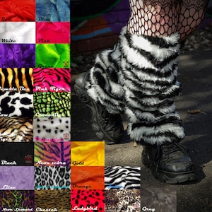 May include: A pair of black and white zebra print leg warmers made of faux fur. The leg warmers are worn over black fishnet tights and black platform shoes. The leg warmers are shown against a background of various colours and animal prints.