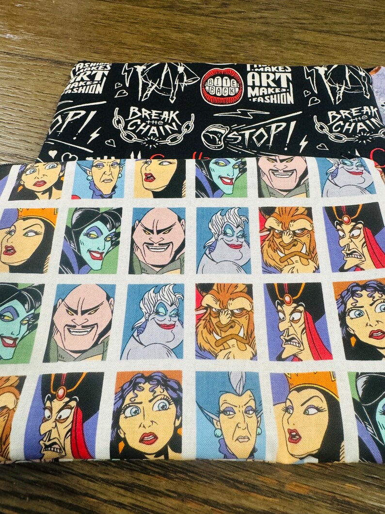 May include: White fabric with a repeating pattern of cartoon villains from Disney movies. Each villain is in a square frame. The villains include Ursula, Maleficent, Jafar, and the Beast. The fabric has the text "Break the Chain" on it.