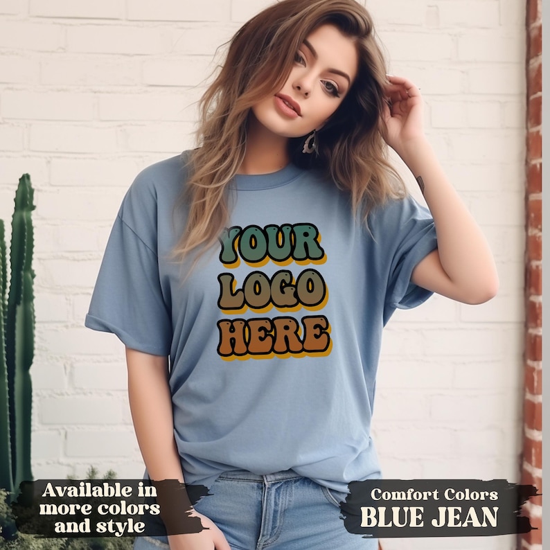 Flat lay of personalized t-shirt with custom uploaded image and text, perfect for matching group shirts for birthdays, girls’ trips, company branding, or school spirit events. DTG printing ensures durable, detailed results on soft cotton fabric. Available from infant to 3XL in Comfort Colors, Softstyle, or sweatshirt formats. Great gift for family, friends, or coworkers.
