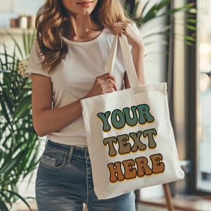 Reusable personalized tote bag made from premium cotton canvas, perfect for weddings, business branding, or everyday errands. Custom logo or name printed on the front, ideal for eco-conscious gifting, promotional giveaways, or thoughtful personal gifts. Includes durable handles, natural color, and ample space. Great for bridesmaids, teachers, employees, or customer thank-you bags