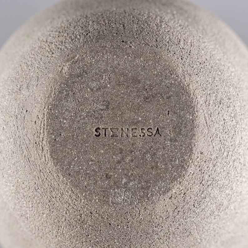 Pode incluir: Close-up da parte inferior de uma tigela de cer&acirc;mica cinza com a palavra "ST&Oslash;NESSA" estampada na parte inferior.