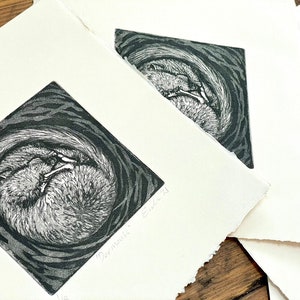 May include: A black and white print of a curled up squirrel sleeping in a nest. The print is signed "Dormouse" and dated "Oct 21".