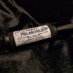 Melancholia Perfume - dark fruit, aged books, and palo santo